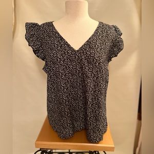 Black ruffle sleeveless blouse with tiny white flowers. Shein XL.
